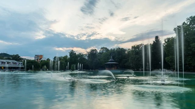Moving from day to night timelapse of the colorful Singing fountains in Tsar Simeon garden in Plovdiv, Bulgaria