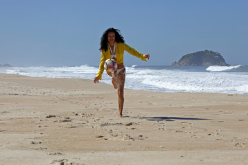 Woman playing ball on the beach