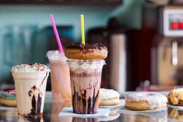 Delicious milkshakes with donuts plastic cups for takeaway in a cafe