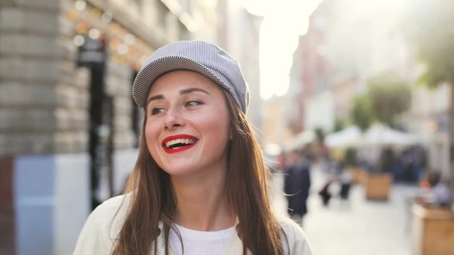 front view of beautiful fashion pretty woman smiling and looking at camera successful business lady happy laughing cheerful face blur city street on background bright sunshine sunny summer day outside