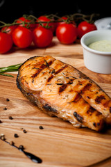 Roasted Grilled Salmon Steak. Salmon with rosemary on a wooden board