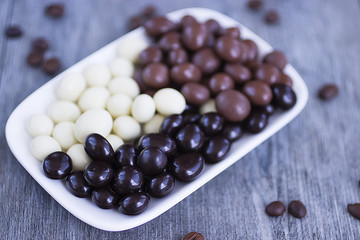 Grains of coffee in glaze of white, milky, and dark chocolate.