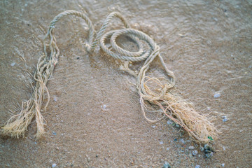 rope tie at sand beach ocean wave vintage color tone