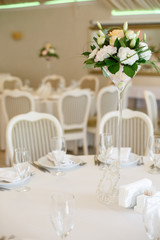 The round table is covered with a white tablecloth