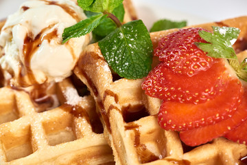 Belgian waffles with strawberries./Belgian waffles with ice cream, strawberries and raspberries.