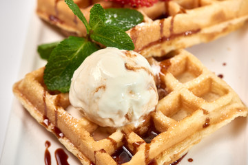 Belgian waffles with strawberries./Belgian waffles with ice cream, strawberries and raspberries.