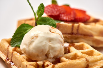 Belgian waffles with strawberries./Belgian waffles with ice cream, strawberries and raspberries.
