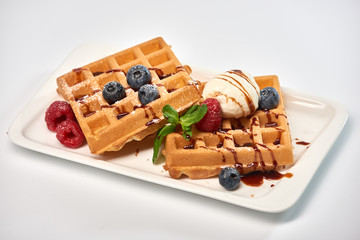Dessert dish. Belgian waffles with ice cream, blueberries and raspberries.