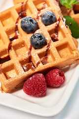 Dessert dish. Belgian waffles with ice cream, blueberries and raspberries.