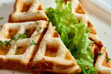 Waffle sandwich with ham and salad./Crispy sandwich with ham and salad. Breakfast.