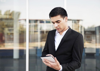 Young businessman working on tablet