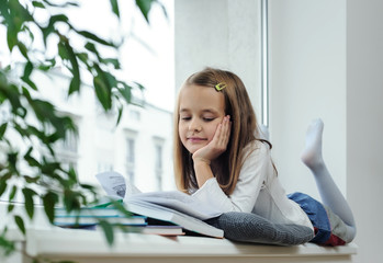 The girl is reading a book.