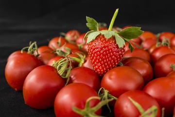 tiny cherry tomatoes and strawberries, colors, tastes the same but different,
