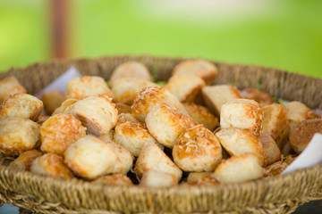 Delicious traditional hungarian baked snack with cheese in basket, outdoor