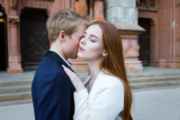 fashion portrait of beautiful young couple posing outdoors