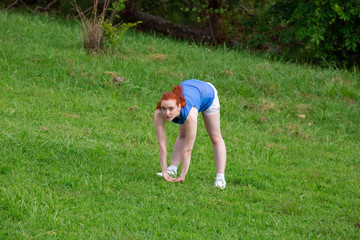 Fototapeta na wymiar a girl is doing sports exercises in the park
