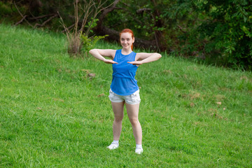 a girl is  doing sports exercises in the park