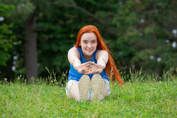 a girl is  doing sports exercises in the park