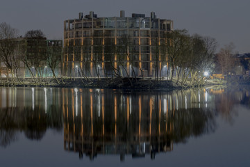 Modern office building with night ilumination, close to river.