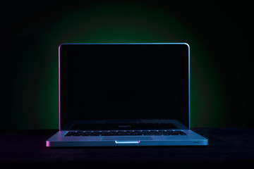 Portable modern silver computer on a black background.