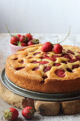 Strawberry cake on a white wooden background