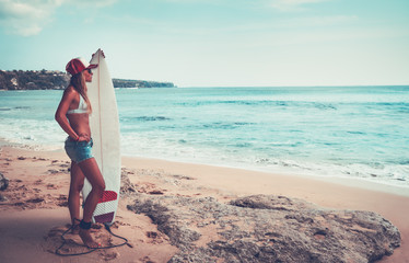 Beautiful surfer girl on the beach