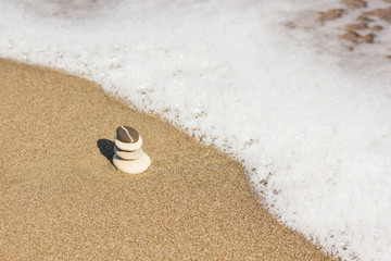 Fototapeta na wymiar Balanced several Zen stones on beautiful the beach background