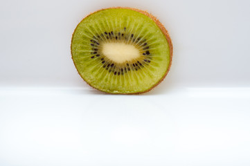 sweet ripe kiwi fruits on white, Kiwi cut into slices lay on a yellow plate, serving fruit