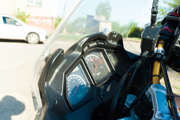 three part, red color dashboard of the car and kilometer gauge.