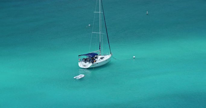 aerial view of sailboat anchored in tropical lagoon with dramatic light in the Caribbean