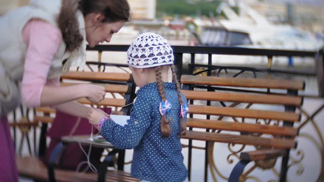 Little stylish beautiful gerl, on city streets listening to music in l headphones.