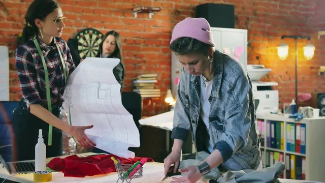 Fashion designers training on master class for sewing clothes in creative studio