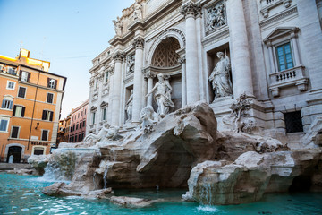 Fototapeta na wymiar Trevi fountain at sunrise, Rome, Italy. Rome baroque architecture and landmark. Rome Trevi fountain is one of the main attractions of Rome and Italy. Panorama. Panoramic view