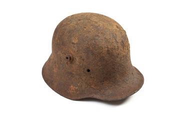 Vintage M1916 German Imperial Army steel helmet, or stahlhelm, used in World War I in rusty condition, isolated on white