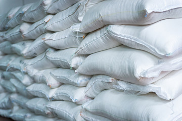 Stack of sugar or flour bags in warehouse