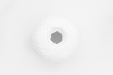 one skeins of white thread on white background, abstract background