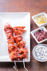 Chicken tandoori skewers with rice and sauces