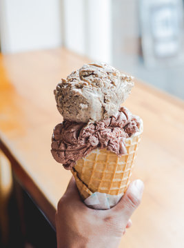 Ice cream - coffee flavors - brown ice - waffle cone - handheld