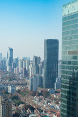 Fototapeta na wymiar Residential buildings amongst sky scrapers - Shanghai