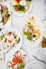 Catering table set service with silverware and glass stemware at
