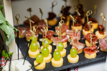 Cheese assortment plate on dark wooden background, free space. T