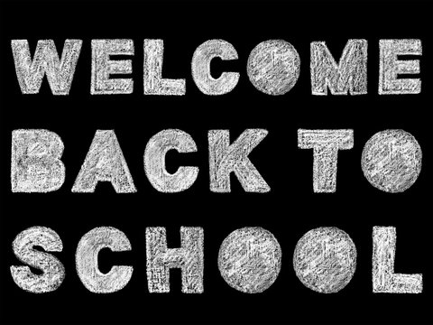 handwritten white bold chalk lettering welcome back to school text on black background, hand-drawn chalk phrase, back to school concept, stock photo image