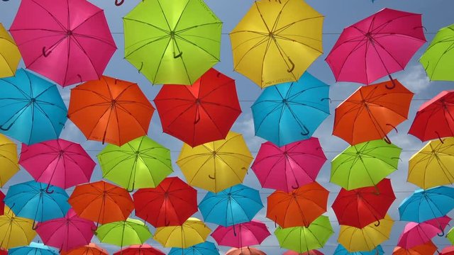 Colorful umbrellas hanging in the sky