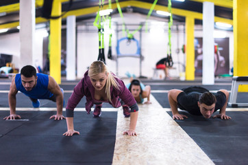 young healthy people doing pushups