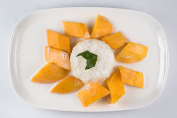 mango sticky rice or Khaoniao mamuang isolated on white background, a traditional thai dessert made with glutinous rice,fresh mango and coconut milk