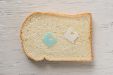 Cut loaf of bread and slice on wood background.Set of three slices toast bread.