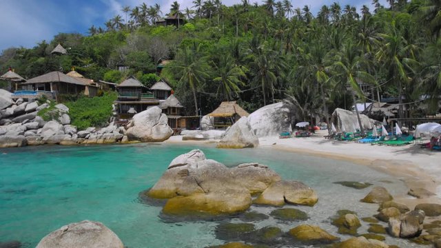 Blue bay with granite stones and palm trees on luxury exotic beach in tropical island, Koh tao, Thailand