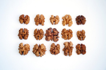 peeled halves of walnut on white background