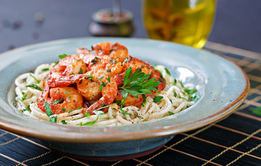 Pasta spaghetti with shrimps, tomato and chopped parsley. Healthy food. Italian meal.