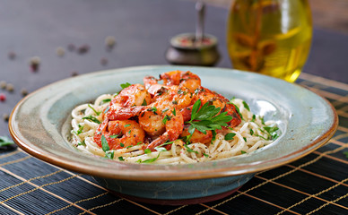 Pasta spaghetti with shrimps, tomato and chopped parsley. Healthy food. Italian meal.